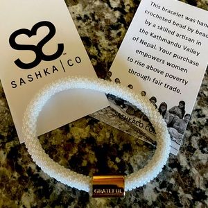 SASHKA Bracelet White Solid Glass Beaded with gold GRATEFUL bead.